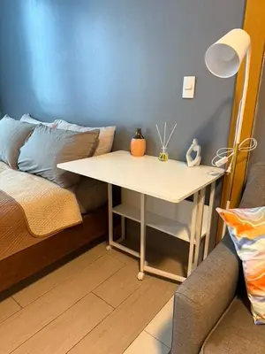 a table in a room with a bed and a bed gmaxwell gmaxwell gmaxwell at One Bedroom with Netflix at Uptown Residences, BGC, Taguig in Manila