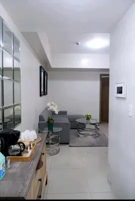 a living room with a couch and a table at 5A Southwing in Manila