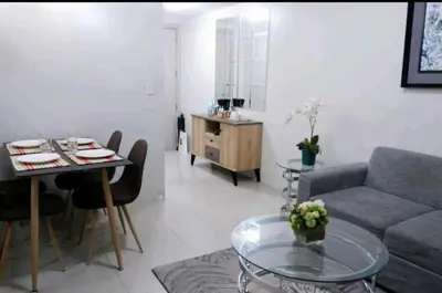 a living room with a couch and a table at 5A Southwing in Manila