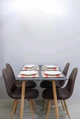 a table with chairs and plates and glasses on it at 5A Southwing in Manila