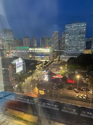 a city at night with a train on a street at Faith Studio Cubao in Manila