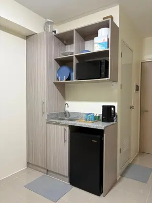 a kitchen with a sink and a counter top at Faith Studio Cubao in Manila
