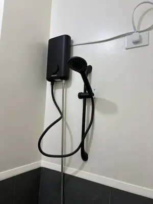 a black phone is hanging on a wall at Faith Studio Cubao in Manila