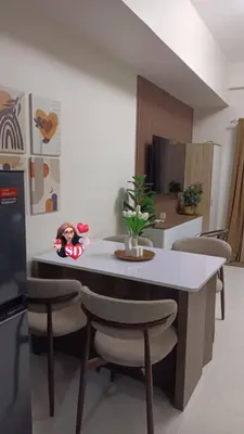 a kitchen with a table with a doll sitting on it at Condotels Near Sucat Skyway in Manila