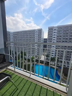 a balcony with a view of a building at J&W Homestay in Manila