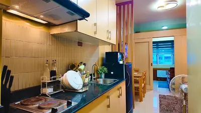 a kitchen with a sink and a counter top at Sea Residence 1BR unit 5 to 10 min walk to MOA by Angels Cozy Corner in Manila