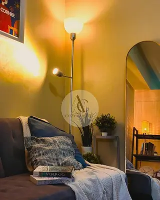 a living room with a couch with books on it at Sea Residence 1BR unit 5 to 10 min walk to MOA by Angels Cozy Corner in Manila