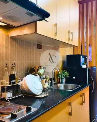 a kitchen with a sink and a counter top at Sea Residence 1BR unit 5 to 10 min walk to MOA by Angels Cozy Corner in Manila