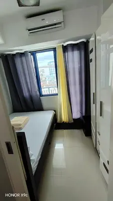 a small room with a bed and two windows at Moa SEA RESIDENCE condotel in Manila