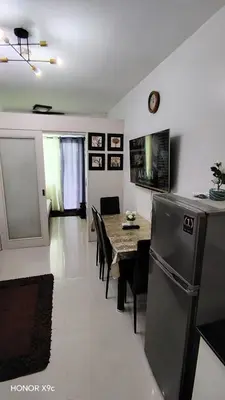 a kitchen and dining room with a table and chairs at Moa SEA RESIDENCE condotel in Manila