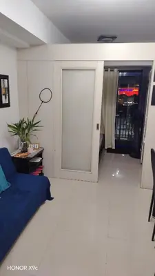 a living room with a sliding door in a room at Moa SEA RESIDENCE condotel in Manila
