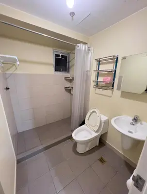 a bathroom with a toilet and a sink at Leo's Master bedroom in Manila