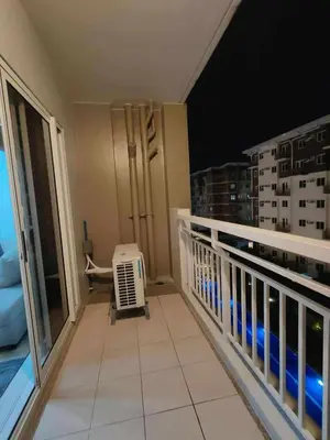 a balcony of a apartment with a heater at Condotels by San Antonio in Manila