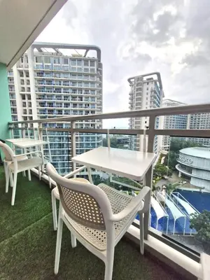 a balcony with tables and chairs and buildings at Condotels by San Antonio in Manila