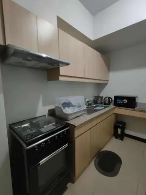 a small kitchen with a stove and a sink at Condotels by San Antonio in Manila