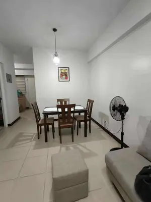 a living room with a dining room table and chairs at Condotels by San Antonio in Manila