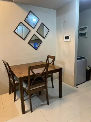 a dining room table with two chairs and a mirror at One Palm Tree Villas-Hyuna Place Across Naia T3 Manila in Manila