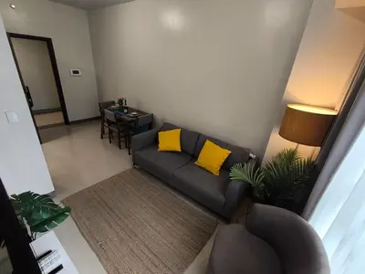 a living room with a couch and a table at Comfortable and Relaxing 1BR Unit in Manila