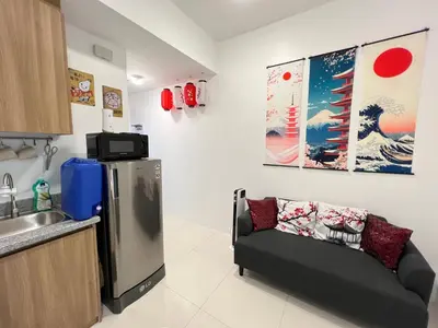 a kitchen with a couch next to a refrigerator at Japan Theme Near Estancia Shaw MRT Kapitolyo Shangrila Mall Megamall Elements in Manila