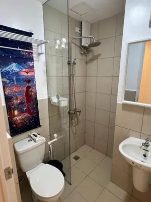 a bathroom with a shower and a toilet and a sink at Japan Theme Near Estancia Shaw MRT Kapitolyo Shangrila Mall Megamall Elements in Manila