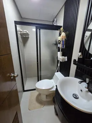 a bathroom with a toilet and a sink at Skye Staycation 2 in Manila
