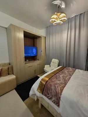 a bedroom with a large bed and a television at Skye Staycation 2 in Manila