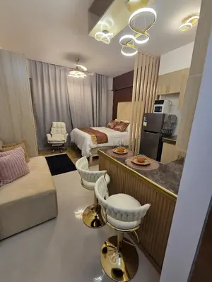 a living room with a kitchen and a bedroom with a bed at Skye Staycation 2 in Manila