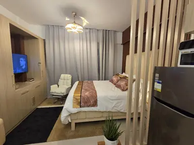 a bedroom with a bed and a television in it at Skye Staycation 2 in Manila