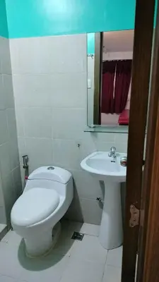 a white bathroom with a toilet and a sink at 2BR Condo FF, Great View, Taguig ,UNDER RENOVATION in Manila