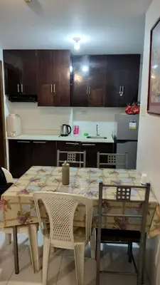 a kitchen with a table and chairs in a room at 2BR Condo FF, Great View, Taguig ,UNDER RENOVATION in Manila