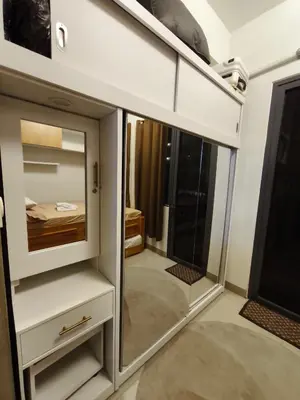 a small room with a mirror and a bedroom at MOA Staycation in Manila