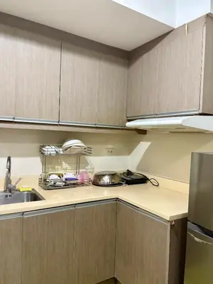 a kitchen with a sink and a counter top at Condo in Poblacion, Makati in Manila