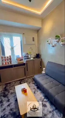 a living room with a couch and a table at Eutopia Vista- 2 Bedroom Condo in SMDC Bloom in Manila