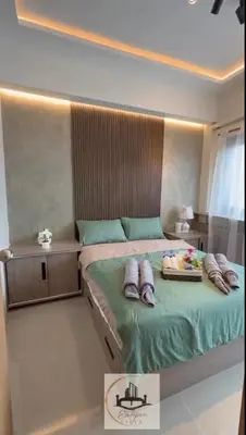 a bedroom with a bed with shoes on it at Eutopia Vista- 2 Bedroom Condo in SMDC Bloom in Manila