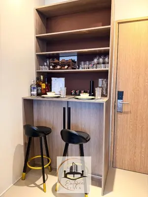 a bar with two stools in front of a counter at Eutopia Vista- 2 Bedroom Condo in SMDC Bloom in Manila