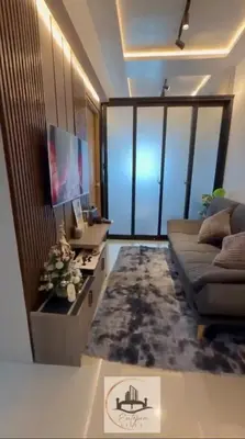 a living room with a couch and a television in it at Eutopia Vista- 2 Bedroom Condo in SMDC Bloom in Manila