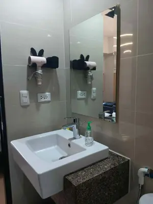 a bathroom with a white sink and a mirror at Cluster 1 9N in Manila