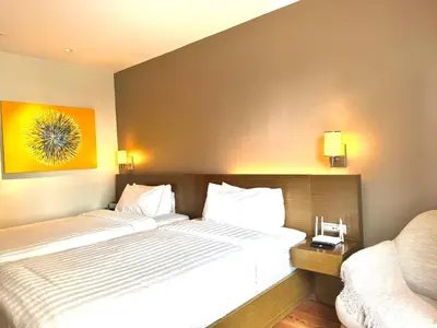 a hotel room with a bed and a couch at Mesmerizing Twin Bed with Rockwell View in Manila
