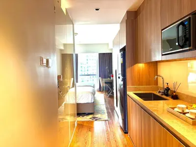a kitchen with a sink and a bed in a room at Mesmerizing Twin Bed with Rockwell View in Manila