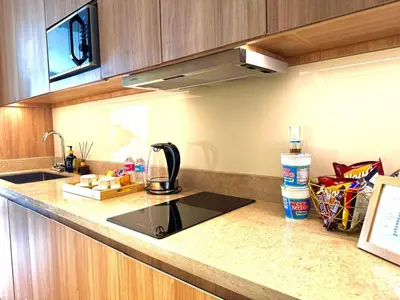 a kitchen with a sink and a counter top at Mesmerizing Twin Bed with Rockwell View in Manila