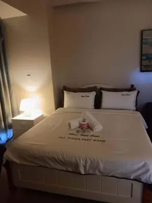 a bedroom with a large white bed with two pillows at Cluster 4 7G in Manila