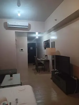 a living room with a couch and a table at Cluster 4 7G in Manila