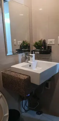 a bathroom with a white sink and a mirror at Cluster 4 7G in Manila