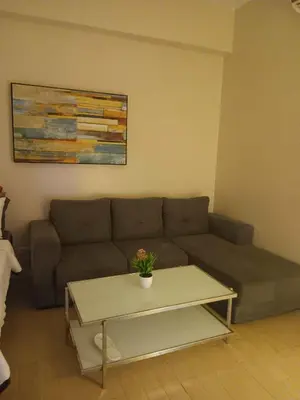 a living room with a couch and a coffee table at Cluster 4 7G in Manila