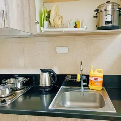 a kitchen counter with a sink and a stove at S Residences by Seren View-main in Manila