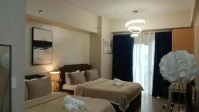 a hotel room with two beds and a couch at Cluster 4 5D in Manila