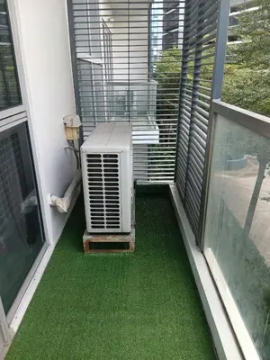 an air conditioner on a balcony with green flooring at Cluster 4 5D in Manila