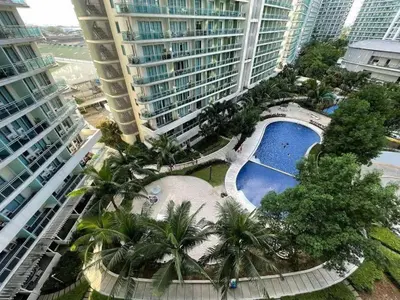 an overhead view of a resort with a pool and palm trees at azure urban resort residences in Manila