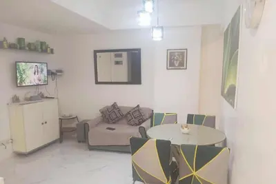 a living room with a couch and a table at azure urban resort residences in Manila