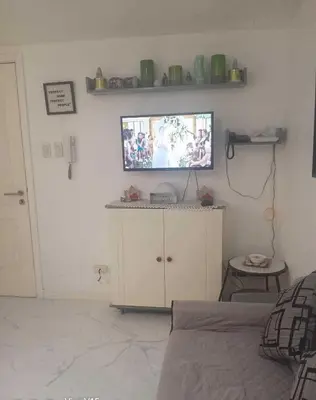 a bedroom with a bed and a tv on a wall at azure urban resort residences in Manila